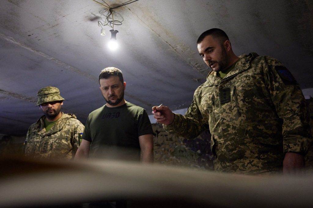 Ukrainian President Volodymyr Zelensky (center) visits the front-line positions of the Ukrainian army.