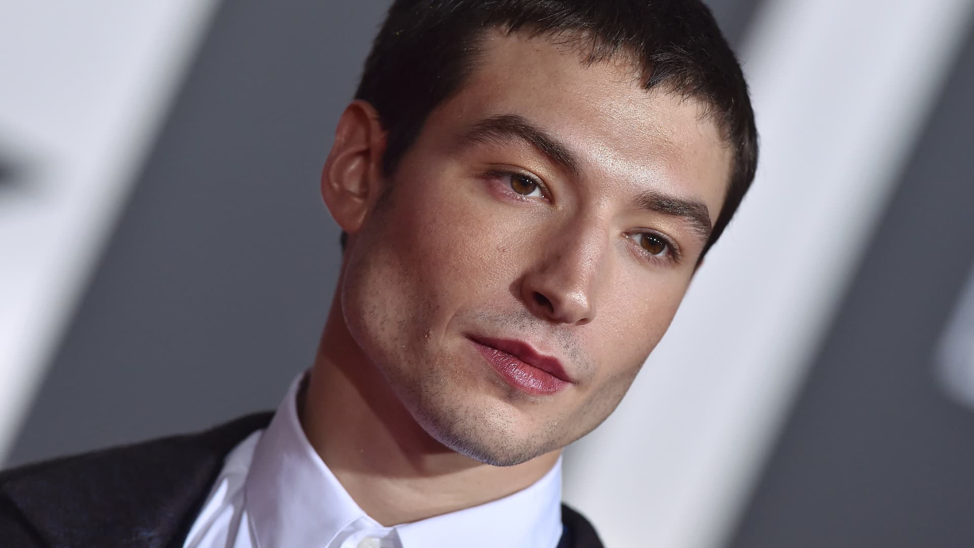 Ezra Miller has been charged with felony burglary days after Warner Bros CEO Discovery Zaslav praised the Flash movie.